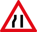 Roadway narrows from the left side ahead