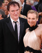 A picture of Quentin Tarantino and German actress Diane Kruger smiling towards the camera