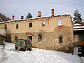 Burned monastery lodgings covered in snow