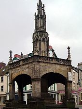Open stone building on five pillars with a spire above.