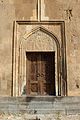 Western portal with a decorative tympanum.