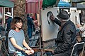 Street artist making a portrait