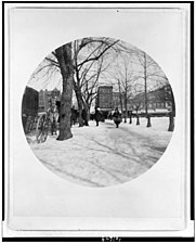 Photo shows the north side of Pennsylvania Avenue with Center Market forming the backdrop for this snowy shopping scene