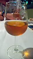 A glass of Vin Santo with its characteristic amber color