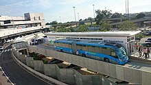 Blue articulated bus at an airport stop