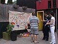 Families paint on the Pride banner, which became an annual tradition.