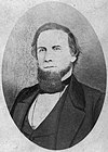Sepia print shows a bearded man in a civilian coat and vest.