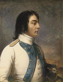 3/4 side portrait of brown-haired man in a white coat.