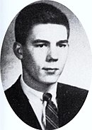 Oval-shaped photo portrait of a young man with short hair wearing a suit