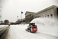 Skid loader clearing snow with snowblower attachment in Minneapolis, MN