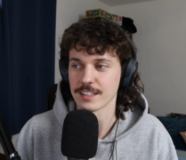 Stand-up comedian Kurtis Conner wearing early 2020s mullet hairstyle and mustache.