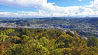 Looking westward towards central Whangārei from the Mount Parihaka lookout, with Te Matau A Pohe bridge and the suburb of Port Whangārei to the far left, the Discovery Settlers Hotel in the suburb of Regent to the far right, as well as Maungatapere and Te Tangihua in the background.