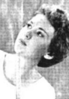 A young white woman with short hair, glancing upward