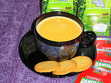 A cup of tea with cookies on the saucer
