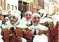 The Gilles of Binche, in costume, wearing wax masks