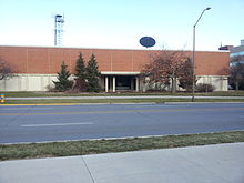 A two-story 1960s brick building on a college campus