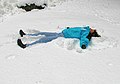 Woman making a snow angel