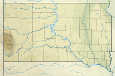 Mapa konturowa Dakoty Południowej, po lewej znajduje się czarny trójkącik z opisem „Mount Rushmore”