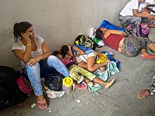 Women and children sleeping on the ground