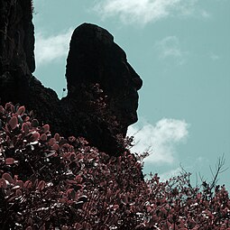 rock which has the profile of a face with blue sky in the background