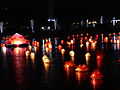 Floating lanterns float along a lake during Vesak in Sri Lanka