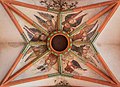 Gothic Holy Ghost hole framed by 15th-century frescos at Church of the Holy Spirit, Heidelberg.