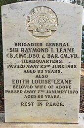 a colour photograph of a white marble gravestone