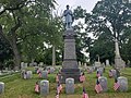 View of Civil War graves at Mt Olivet Cemetery guarded by a statue of a union soldier