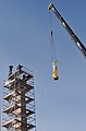 Gëlle Fra lowered by crane from the obelisk, March 2010, for removal to Expo 2010, Shanghai