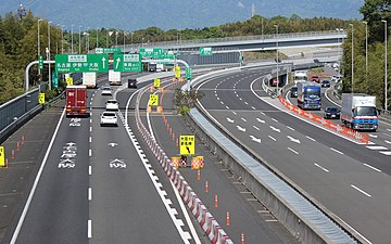 A group of green-colored directional signs on a Japanese expressway