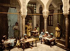 Women stitching inside a hall