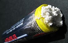 Potassium carbonate, formed from the hydroxide solution leaking from an alkaline battery