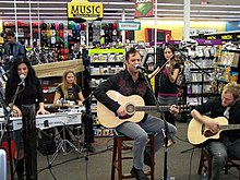 Skillet performing at a promotional acoustic show in Denton, TX