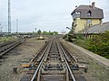 Image 39The "hump" of a hump yard. Railcars travel past retarders, which control their speed, and are directed onto tracks to be assembled into new trains. The control tower operates the retarders. (from Rail yard)