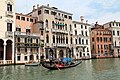 Gondolier sailing on the Grand Canal in front of Palazzo Michiel del Brusà in Venice.