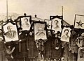 Image 2Russian peasants holding banners of Lenin (left), Marx (centre) and Trotsky (right) in early Soviet Russia. (from Russian Revolution)