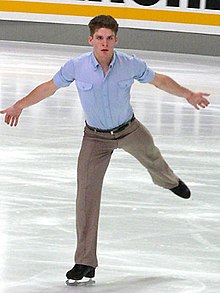 Vaughn Chipeur wearing tan slacks and a light blue short-sleeved shirt, performing on the ice