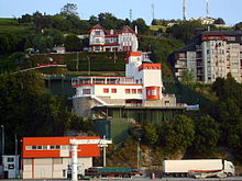 Modern house among others on the side of a hill