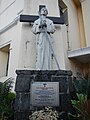 A statue of St. Pedro Bautista next to the original façade