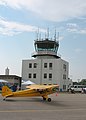 A Piper J3C-65 Cub taxis by the control tower during the 2007 Crystal Airport Open House and Fly-In