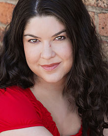 A longhaired woman wearing a red shirt