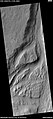 Streamlined feature in the Mangala Valles, as seen by HiRISE under the HiWish program. Many dark slope streaks are visible. Location is Memnonia quadrangle.