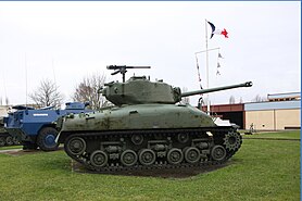 A M4 Sherman tank profile view and a VXB-170 Berliet partially hidden by the tank.