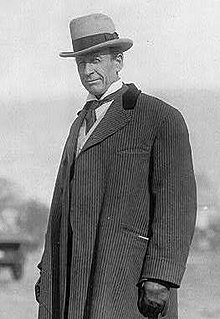 Black-and-white photo of man in hat