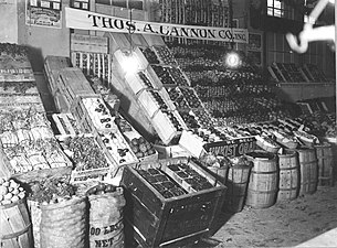 A combined wholesale and retail stand in Center Market. Note the great variety and attractiveness of the products. See iced refrigerator box of Florida strawberries in foreground, also Florida celery and tomatoes, and California cauliflower and artichoke