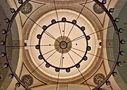 Intricate inscriptions surround the interior of a dome shot from below