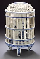 Late 19th century birds in a cage; a showpiece of openwork