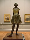 Little Dancer of Fourteen Years, cast in 1922 from a mixed-media sculpture modeled ca. 1879–80, Bronze, partly tinted, with cotton skirt and satin hair ribbon, on a wooden base, Metropolitan Museum of Art, New York City
