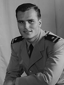 Black and white portrait photograph of Kelly in 1951. He is looking directly into the camera.