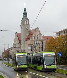 Two trams in front of a town hall